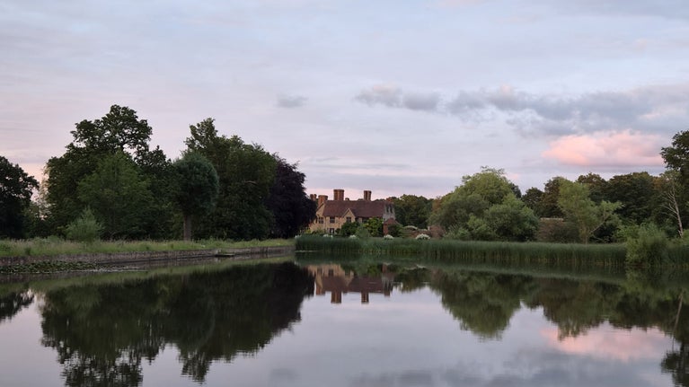 A view of Packwood House, Warwickshire, taken across the lake